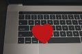 Computer with red hearts on table close up Royalty Free Stock Photo