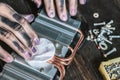 Computer repair master with dark dirty hands cleaning the electronic piece on the table f Royalty Free Stock Photo