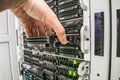 Computer repair in the server room of the data center. The specialist performs the replacement of the hard disk in the data Royalty Free Stock Photo