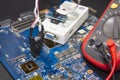 Computer repair service. Engineer repairing laptop mainboard. Bios chip programing Royalty Free Stock Photo