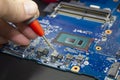 Computer repair service. Engineer repairing laptop mainboard. Hardware developer measure electronic components Royalty Free Stock Photo