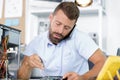 computer repairman on phone while repairing desktop computer Royalty Free Stock Photo