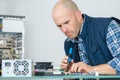 Computer repairman using soldering iron