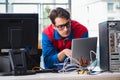 The computer repairman working on repairing computer in it workshop Royalty Free Stock Photo