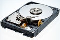 A computer`s hard disk hdd data storage drive without shield isolated  in white background show magnetic disc and electronic part Royalty Free Stock Photo