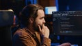 Computer scientist drinking cup of coffee while developing code on PC Royalty Free Stock Photo