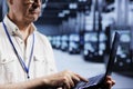 Computer scientist examining servers