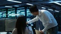 Computer scientists in data center managing and maintaining databases