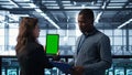 Computer scientists in data center use mockup tablet, inspecting server rigs