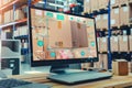 Computer screen displaying content with a box placed on top, in a warehouse setting, Incremental delivery of working software Royalty Free Stock Photo