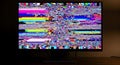 Computer screen displaying static and colorful digital noise, symbolizing signal loss and technical problems Royalty Free Stock Photo
