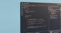 A computer screen displays a code editor with several lines of colorful code, Royalty Free Stock Photo
