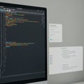 A computer screen displays a development environment with code written in a dark- Royalty Free Stock Photo