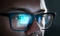 Computer screen light reflect from glasses. Close up of eyes. Royalty Free Stock Photo
