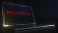 Portable computer with the logo of HONDA made with code strings, editorial conceptual 3d rendering