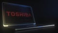 Portable computer with the logo of TOSHIBA made with code strings, editorial conceptual 3d rendering