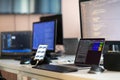 Computer screens running programming code in empty software developing agency office and computers parsing data Royalty Free Stock Photo