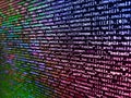 Computer script coding source code on desktop monitor. Data bits computer bits, shadow and dark vignette effect. Shallow depth of Royalty Free Stock Photo