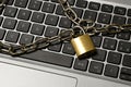 Computer security concept with an iron chain and padlock on the laptop keyboard Royalty Free Stock Photo