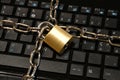 Computer security concept with an iron chain and padlock on the laptop keyboard Royalty Free Stock Photo