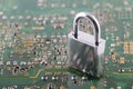 Computer security concept. Padlock on green computer circuit board Royalty Free Stock Photo