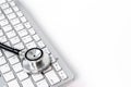 Computer servise and repair concept - kayboard with stethoscope Royalty Free Stock Photo