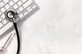 Computer servise and repair concept - kayboard with stethoscope Royalty Free Stock Photo
