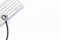 Computer servise and repair concept - kayboard with stethoscope Royalty Free Stock Photo