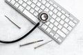 Computer servise and repair concept - kayboard with stethoscope Royalty Free Stock Photo