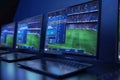 Computer setup with multiple screens displaying live football match statistics and betting odds Royalty Free Stock Photo