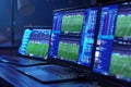 Computer setup with multiple screens displaying live football match statistics and betting odds Royalty Free Stock Photo