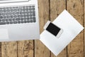 Computer, smartphone and paper on wood table Royalty Free Stock Photo