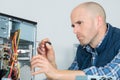 Computer specialist use screwdriver to repair hardware