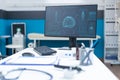 Computer standing on table in empty doctors office having body radiography