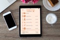 computer tablet with app tracking delivery package and phone cafe Royalty Free Stock Photo