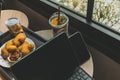 Computer tablet with desserts and Iced drink. Concept of working in cafe. Royalty Free Stock Photo