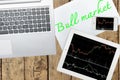 Computer, tablet, smartphone and paper with text bull market on Royalty Free Stock Photo