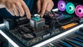 Computer technician applying thermal paste to CPU processor during motherboard assembly with precision tools and RGB cooling fans Royalty Free Stock Photo