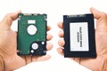 Computer technician compares a SATA harddisk to a Solid State Drive SSD harddisk Royalty Free Stock Photo