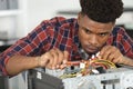 Computer technician examining cables in pc