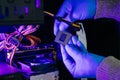 Computer technician in gloves safely repairing desktop hardware. Close-up view of hands fixing GPU and motherboard inside open PC Royalty Free Stock Photo