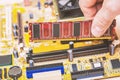 Computer technician installing computer memory RAM in the slot of the motherboard Royalty Free Stock Photo