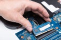 Computer technician installing laptop memory RAM in the slot of the motherboard Royalty Free Stock Photo