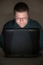 Computer user in darkened room