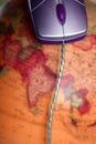 Computer wired mouse over the world global earth Royalty Free Stock Photo
