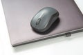 Computer wireless mouse next to a laptop on a white table close-up. electronic personal industry Royalty Free Stock Photo