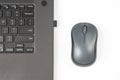 Computer wireless mouse next to a laptop on a white table close-up. electronic personal industry Royalty Free Stock Photo