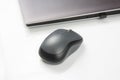 Computer wireless mouse next to a laptop on a white table close-up. electronic personal industry Royalty Free Stock Photo