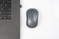 Computer wireless mouse next to a laptop on a white table close-up. electronic personal industry Royalty Free Stock Photo