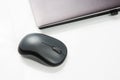 Computer wireless mouse next to a laptop on a white table close-up. electronic personal industry Royalty Free Stock Photo